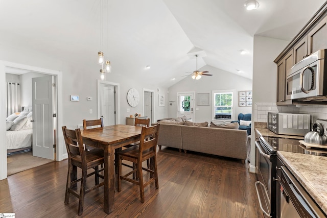 dining space featuring dark wood finished floors, ceiling fan, and vaulted ceiling