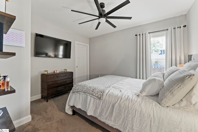 carpeted bedroom featuring baseboards and ceiling fan