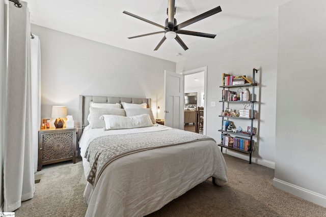 carpeted bedroom with baseboards and a ceiling fan