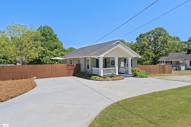 bungalow-style home featuring fence and covered porch