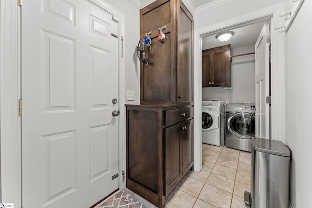 clothes washing area with ornamental molding, cabinet space, light tile patterned floors, and washing machine and dryer