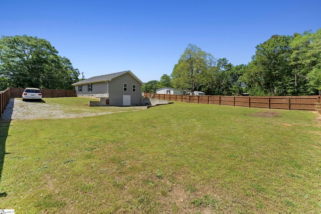 view of yard with a fenced backyard