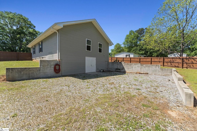 view of side of property with a yard and fence
