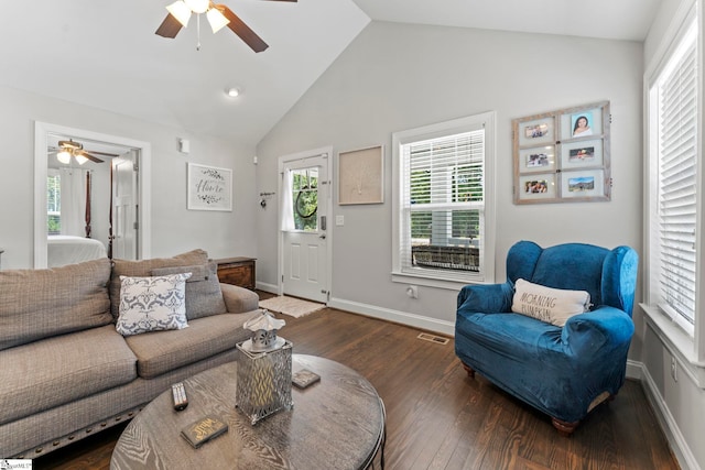 living area featuring ceiling fan, vaulted ceiling, dark wood-style flooring, and visible vents