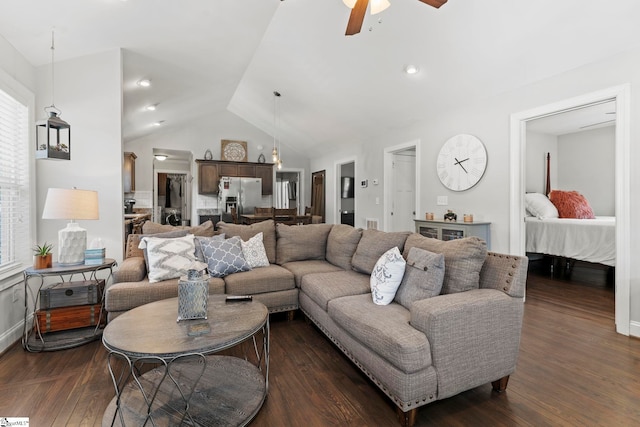 living room with plenty of natural light, a ceiling fan, dark wood-style flooring, and vaulted ceiling