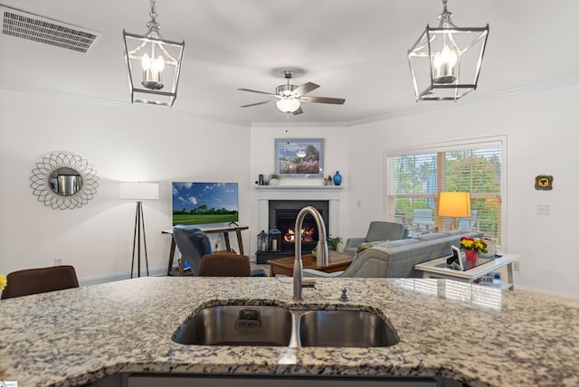 305 Fox Brook Ct, Taylors, SC 29687 - kitchen featuring a sink, light stone countertops, decorative light fixtures, and visible vents