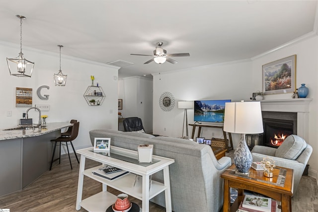 305 Fox Brook Ct, Taylors, SC 29687 - living area featuring crown molding, ceiling fan, a warm lit fireplace, wood finished floors, and visible vents