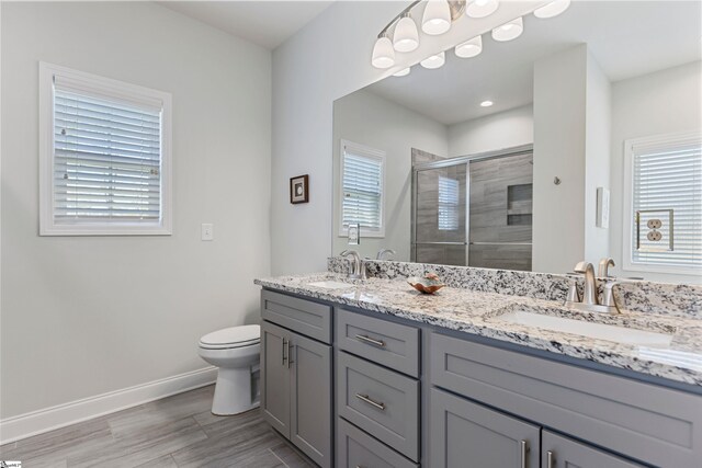 305 Fox Brook Ct, Taylors, SC 29687 - bathroom featuring double vanity, a sink, wood finished floors, and a shower stall