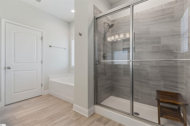 305 Fox Brook Ct, Taylors, SC 29687 - bathroom with recessed lighting, baseboards, a shower stall, wood finished floors, and a garden tub