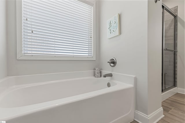 305 Fox Brook Ct, Taylors, SC 29687 - bathroom with plenty of natural light, a shower stall, a bath, and wood finished floors
