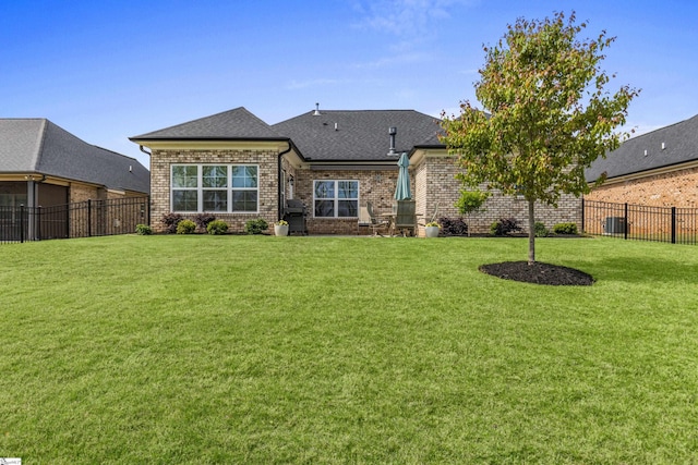 305 Fox Brook Ct, Taylors, SC 29687 - back of property featuring central AC, fence, brick siding, a shingled roof, and a yard