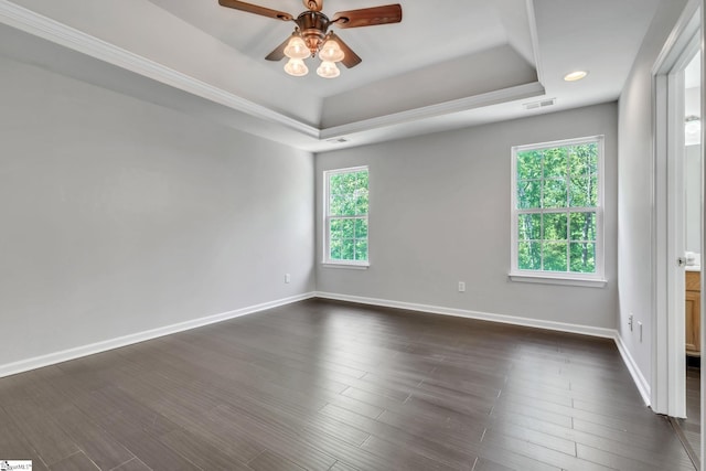 spare room featuring a raised ceiling, ceiling fan, baseboards, and visible vents