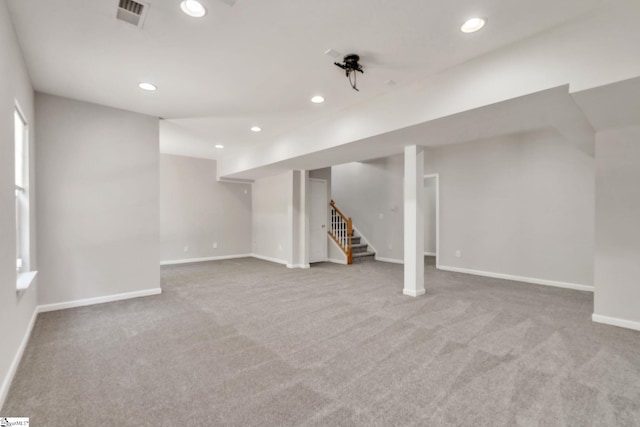 below grade area featuring visible vents, stairs, carpet floors, baseboards, and recessed lighting