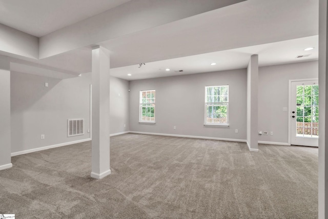below grade area with baseboards, carpet flooring, and visible vents