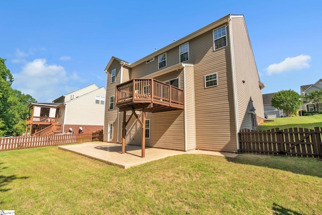 back of property with fence, a patio, a lawn, and a deck