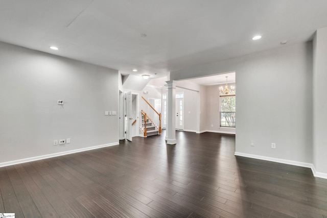 unfurnished living room featuring dark wood finished floors, stairway, baseboards, an inviting chandelier, and recessed lighting