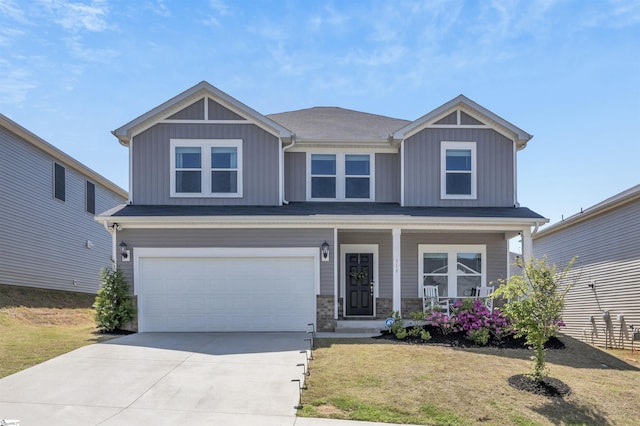 craftsman house featuring a garage, a front lawn, covered porch, board and batten siding, and concrete driveway