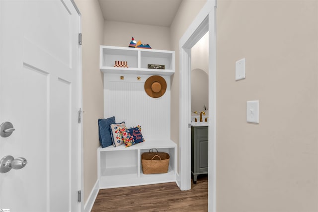 mudroom featuring baseboards and wood finished floors