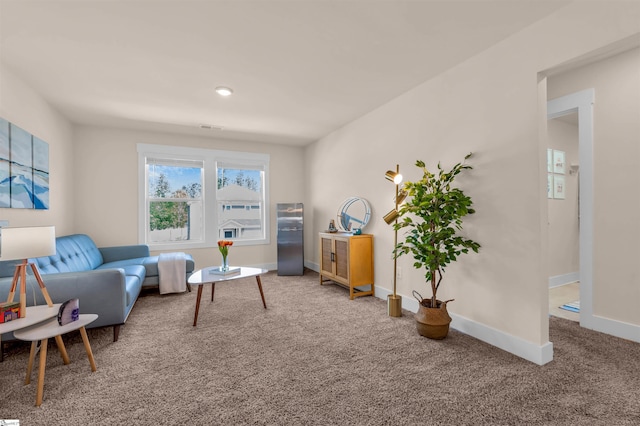 carpeted living room with baseboards and visible vents