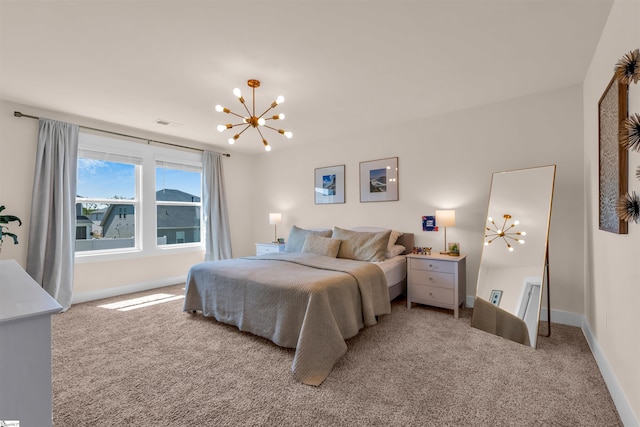 carpeted bedroom featuring baseboards and a chandelier