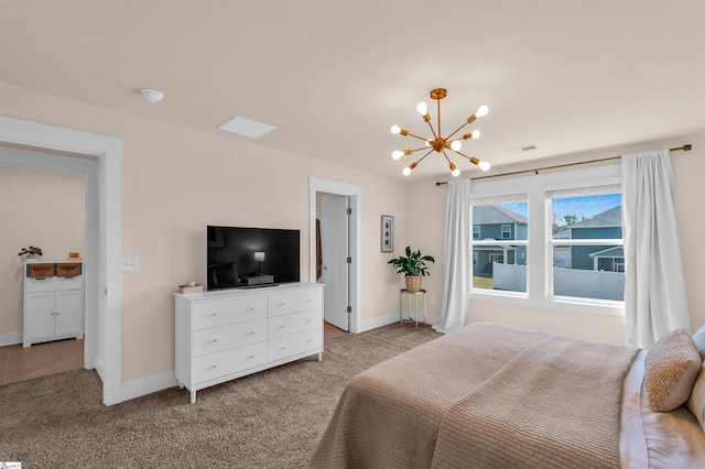 carpeted bedroom with baseboards, a notable chandelier, and visible vents