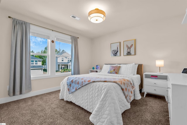 bedroom featuring baseboards, visible vents, and carpet