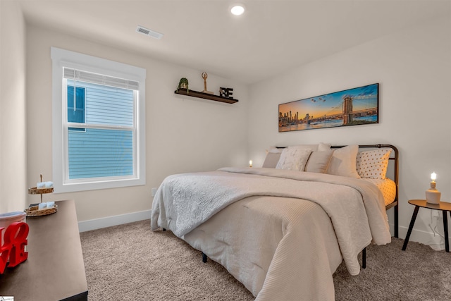 carpeted bedroom featuring visible vents and baseboards