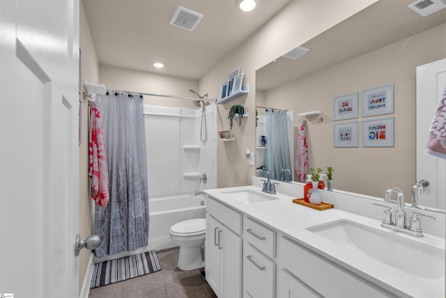 bathroom featuring visible vents, a sink, and tile patterned floors