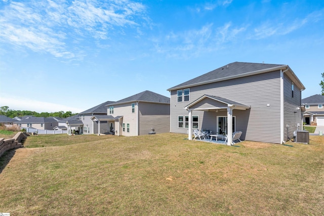 back of property featuring a lawn, central AC unit, and a patio area