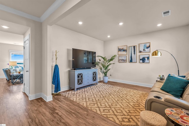 living area with baseboards, recessed lighting, wood finished floors, and visible vents