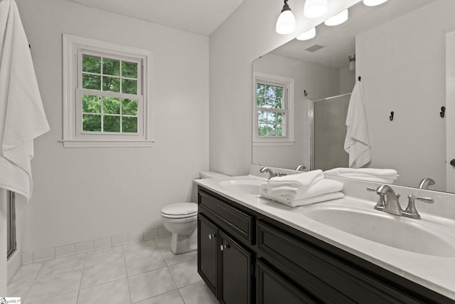 full bathroom with a sink, a stall shower, toilet, and double vanity