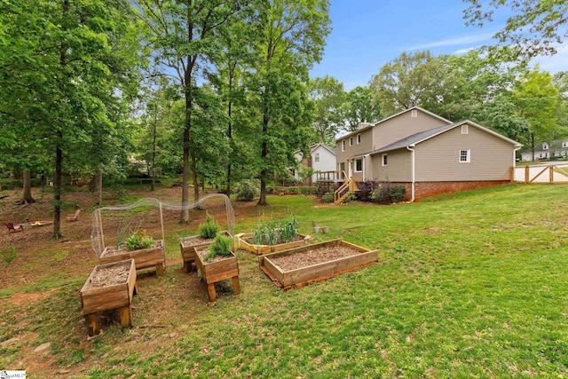 view of yard with fence and a vegetable garden