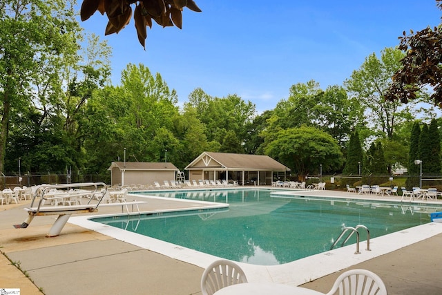 community pool featuring a patio and fence