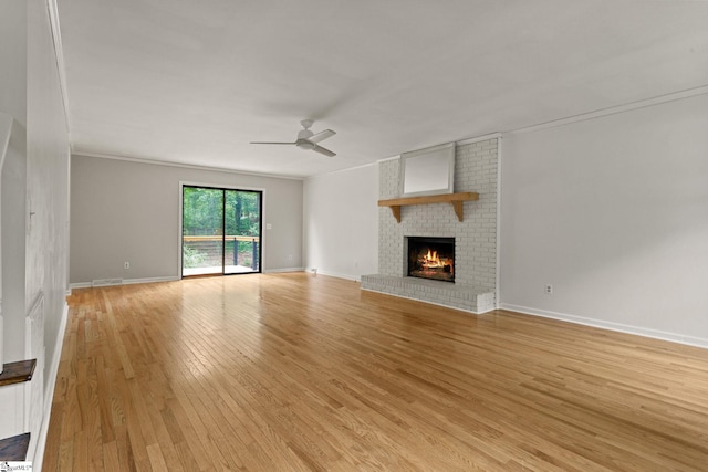 unfurnished living room featuring a fireplace, light wood-style floors, a ceiling fan, baseboards, and visible vents