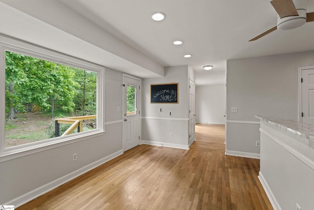 interior space with recessed lighting, baseboards, ceiling fan, and wood finished floors