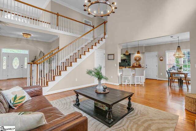 268 Antrim Ave, Moore, SC 29369 - living area with a notable chandelier, ornamental molding, a healthy amount of sunlight, and a towering ceiling