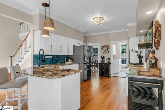 268 Antrim Ave, Moore, SC 29369 - kitchen featuring a breakfast bar area, dark stone counters, white cabinetry, stainless steel fridge with ice dispenser, and a sink