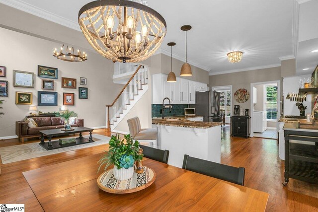 268 Antrim Ave, Moore, SC 29369 - dining area featuring crown molding, a notable chandelier, wood finished floors, and stairway