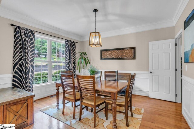 268 Antrim Ave, Moore, SC 29369 - dining room with a chandelier, ornamental molding, a healthy amount of sunlight, and a wainscoted wall