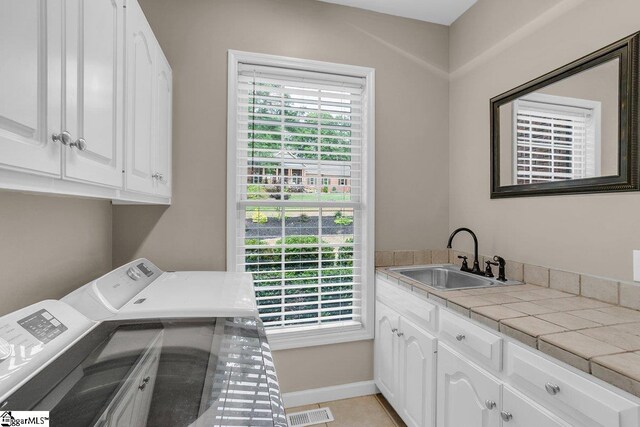 268 Antrim Ave, Moore, SC 29369 - laundry area with visible vents, washer and dryer, baseboards, a sink, and cabinet space