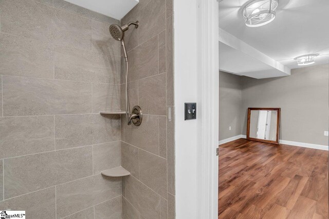 268 Antrim Ave, Moore, SC 29369 - bathroom featuring baseboards, wood finished floors, and tiled shower