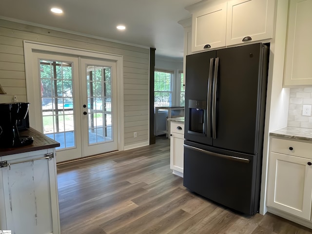 kitchen with backsplash, light wood-type flooring, french doors, and black fridge with ice dispenser