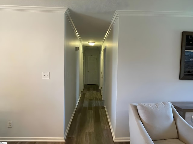 hallway featuring crown molding, attic access, dark wood finished floors, and baseboards
