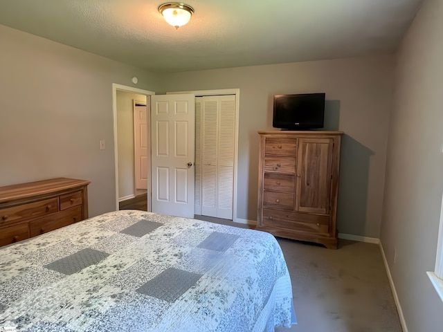 bedroom featuring baseboards, a closet, and carpet flooring