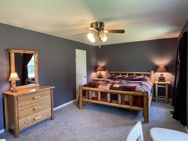 bedroom with carpet floors, a ceiling fan, a textured ceiling, and baseboards