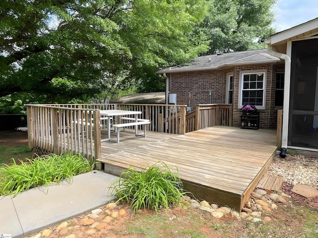 wooden terrace with a grill