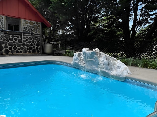 view of swimming pool with fence and a fenced in pool