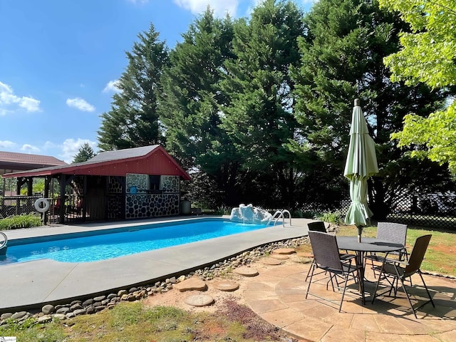 view of pool featuring a patio, fence, and a fenced in pool