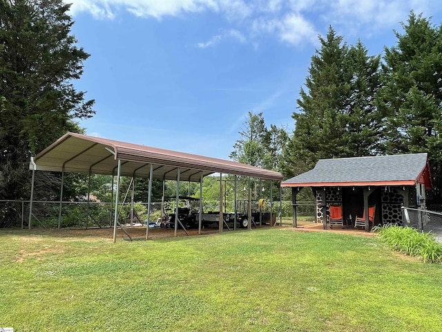 exterior space featuring fence, a yard, and a carport