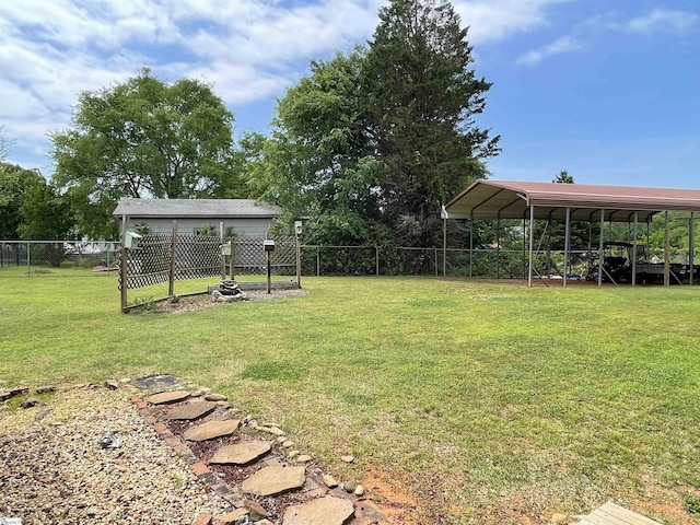 view of yard featuring fence and a carport